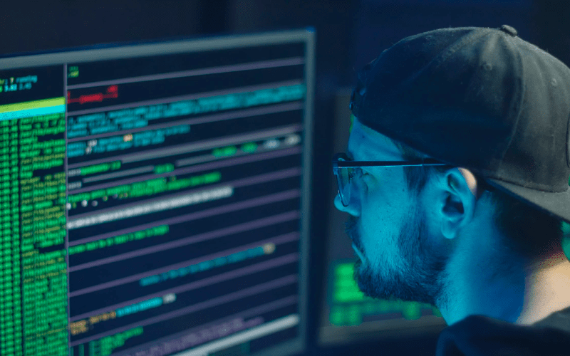 A person's hand on a colorfully lit up keyboard to symbolize investigating network security