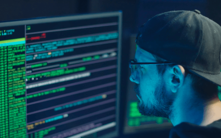 A person's hand on a colorfully lit up keyboard to symbolize investigating network security